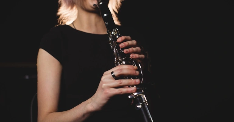 woman holding clarinet