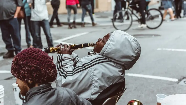 man playing clarinet in the streets