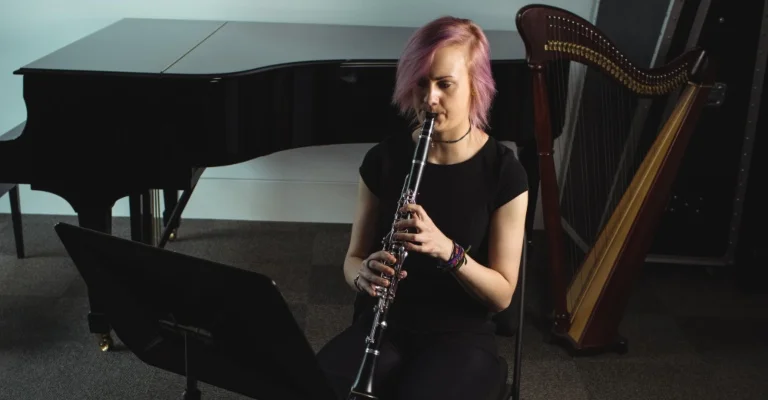 woman playing clarinet in sitting position