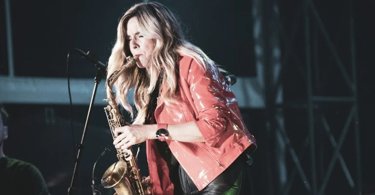 woman playing sax on stage