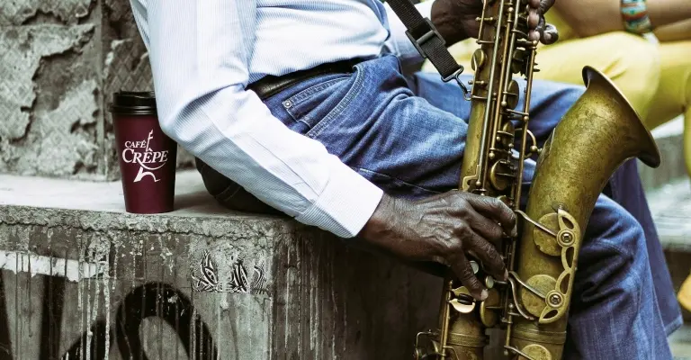 man playing sax while sitting